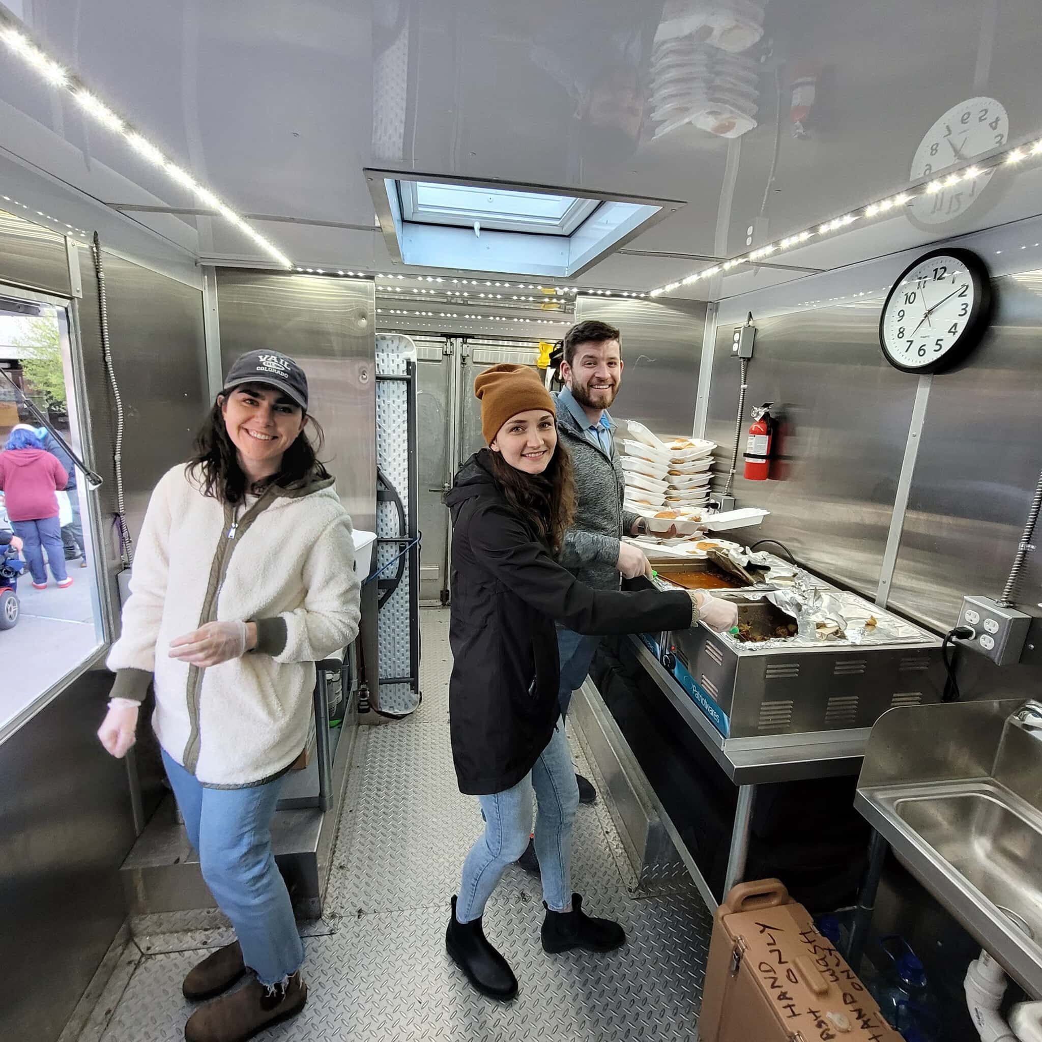 TFH Rochester, NY | The line at Pinnacle Place apartments forms outside the food truck for hot, nutritious meals distributed by a friendly crew of volunteer servants May & June 2022 b